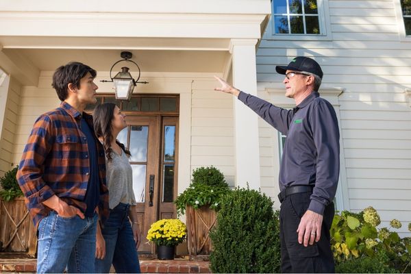 Terminix technician speaking with homeowners